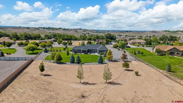 a view of a patio with table and chairs with a barbeque grill and plants
