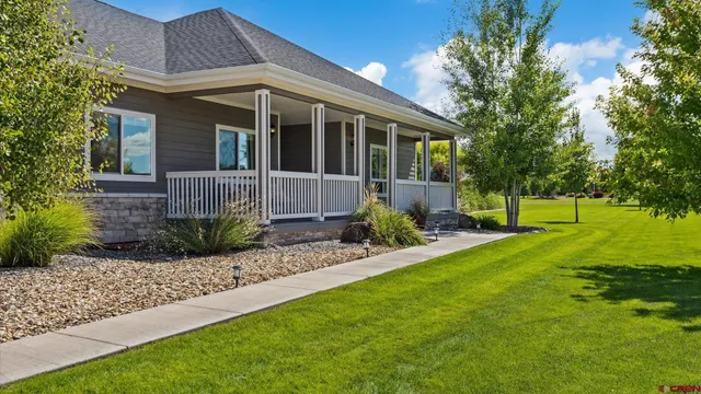 a front view of a house with a garden and porch