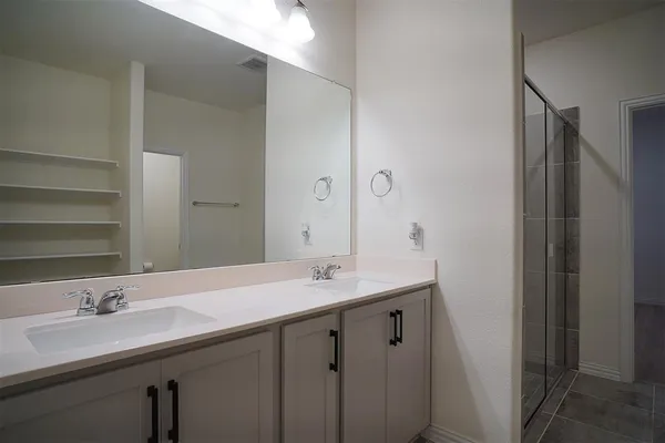 a bathroom with a granite countertop toilet and a sink