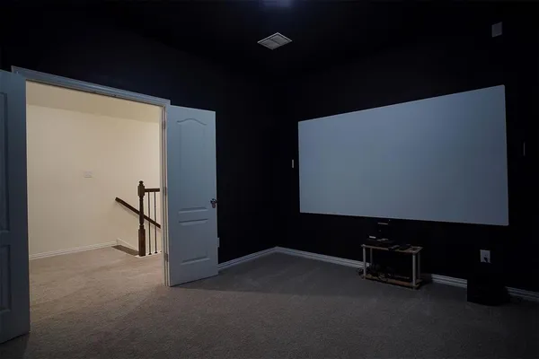 an empty room with fan and windows
