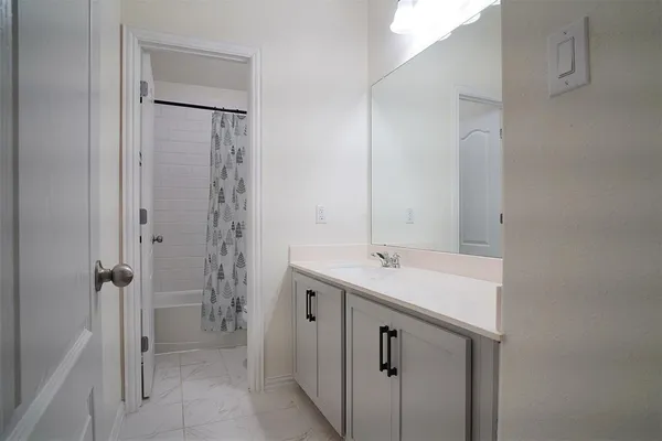 a view of an empty room with closet and a window