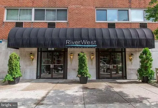 a view of a house with wooden fence