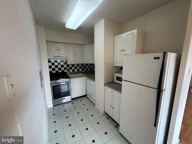 a white refrigerator freezer sitting inside of a kitchen