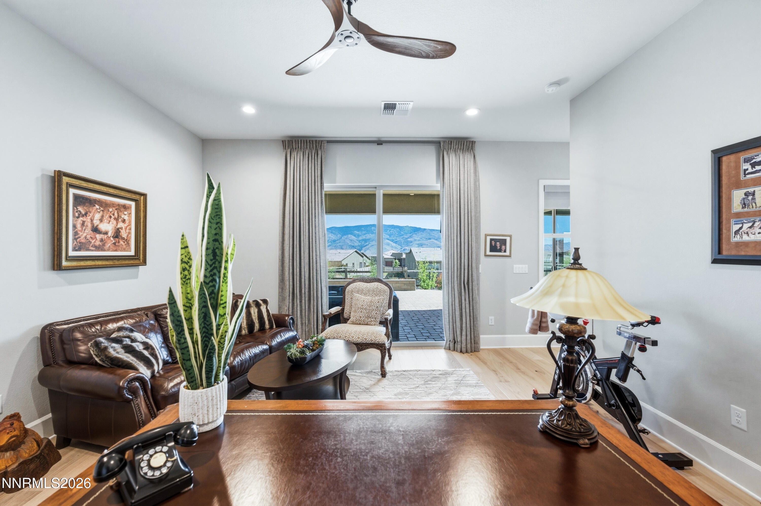 9028 Iron Sky Court Reno, NV 89523 - Photo 26 of 36 a room with furniture a potted plant and a wooden floor