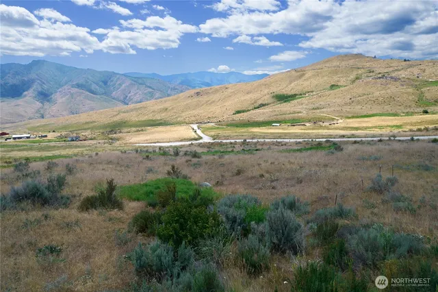 a view of mountain with sunset in background