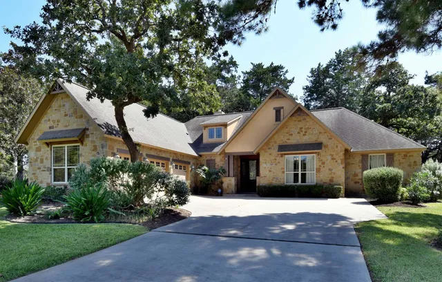 a front view of a house with a garden and plants