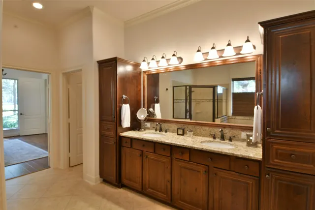 a bathroom with a double vanity sink and a mirror