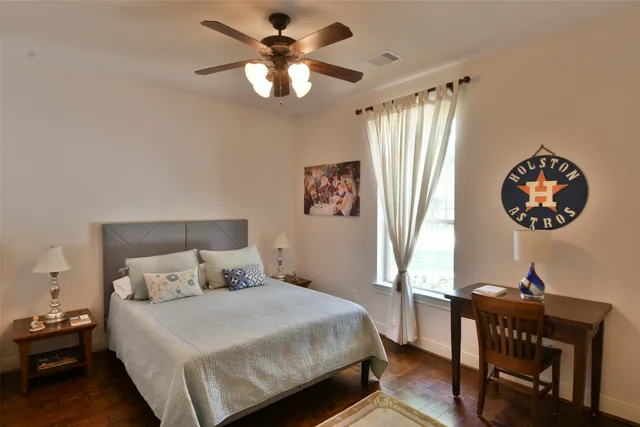 a bedroom with a large bed and a chandelier
