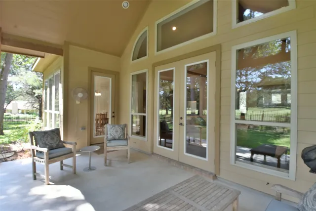 a living room with furniture and a floor to ceiling window