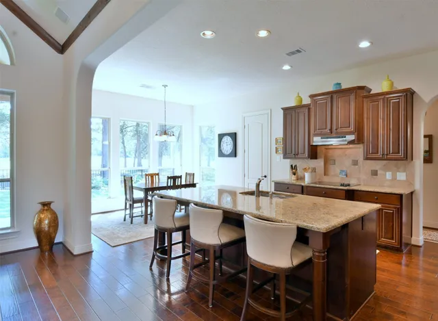 a view of kitchen with granite countertop cabinets table and chairs