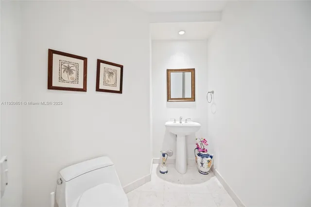 a bathroom with a toilet sink and a shower