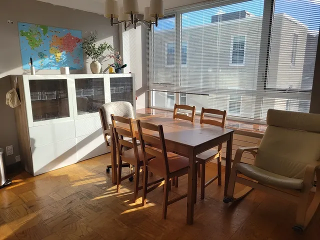 a dining room with furniture and window