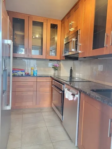 a kitchen with stainless steel appliances granite countertop a sink and cabinets