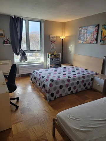 a bedroom with a bed and window