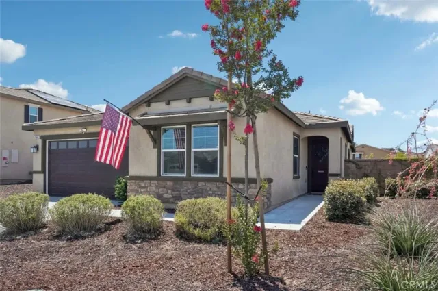 a front view of a house with garden