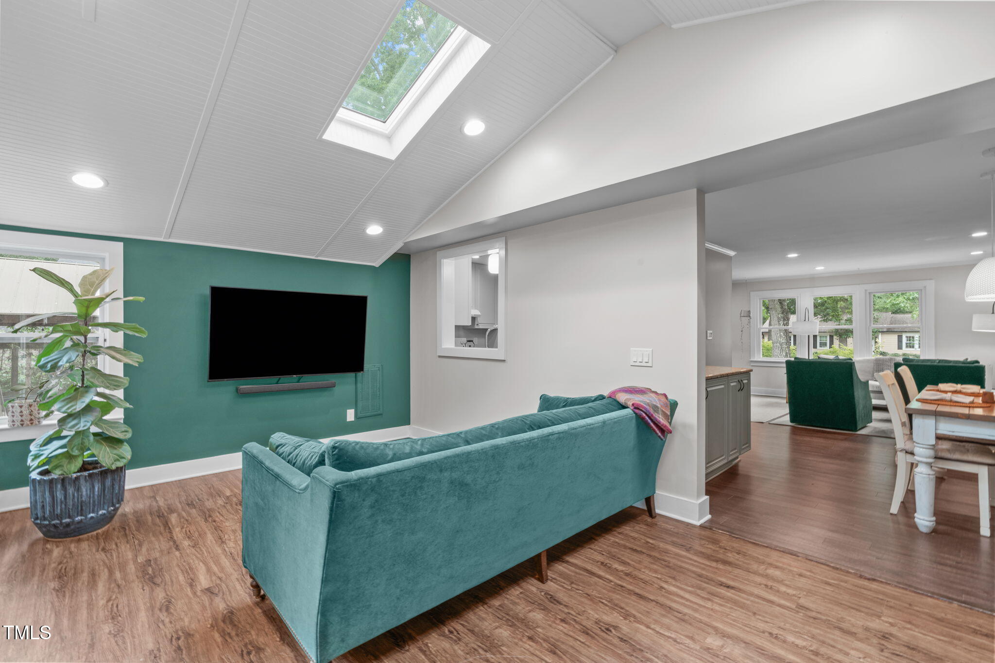 7304 St Ledger Drive Raleigh, NC 27613 - Photo 10 of 29 a living room with furniture and a flat screen tv