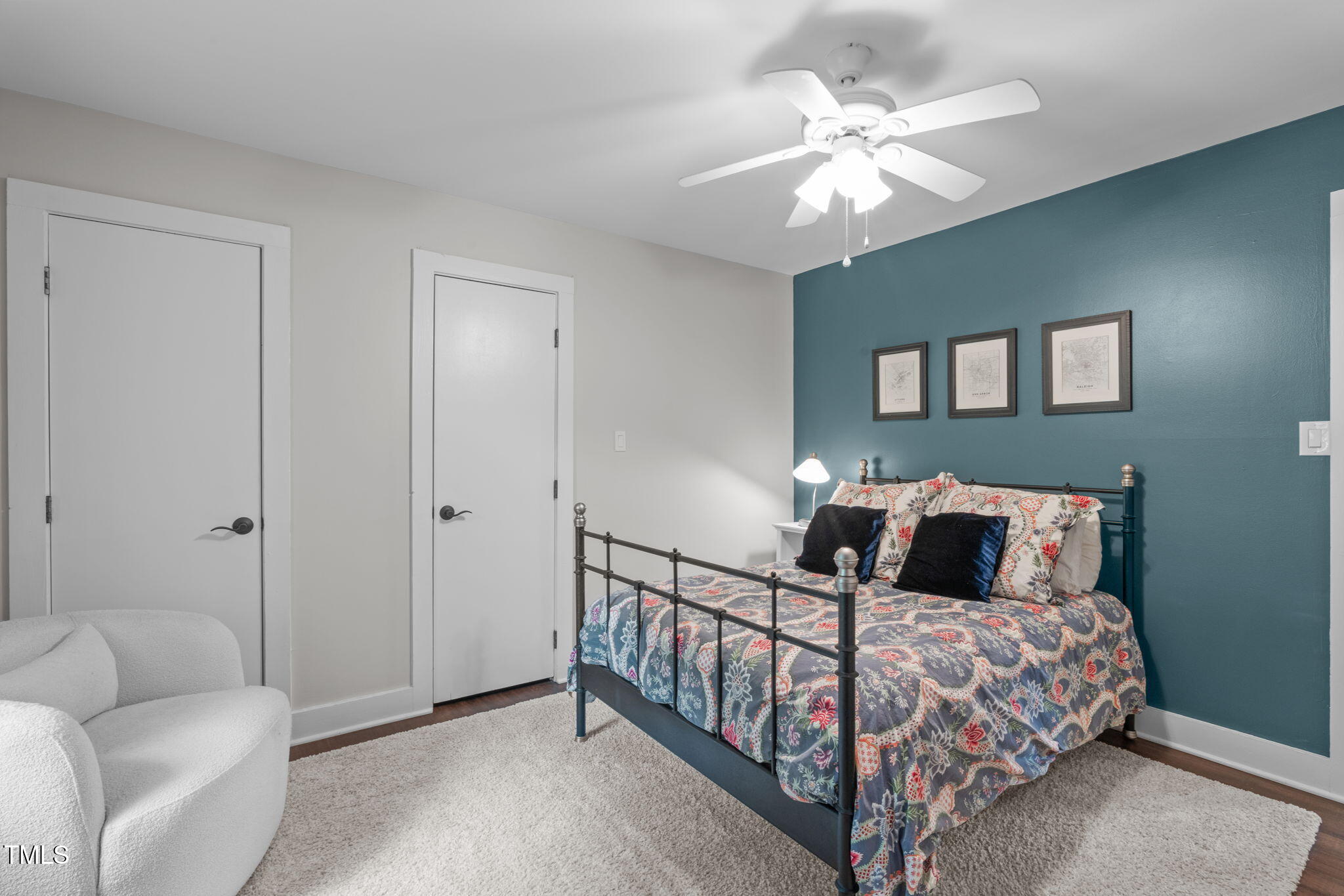 7304 St Ledger Drive Raleigh, NC 27613 - Photo 17 of 29 a bedroom with a bed a chandelier and a couch