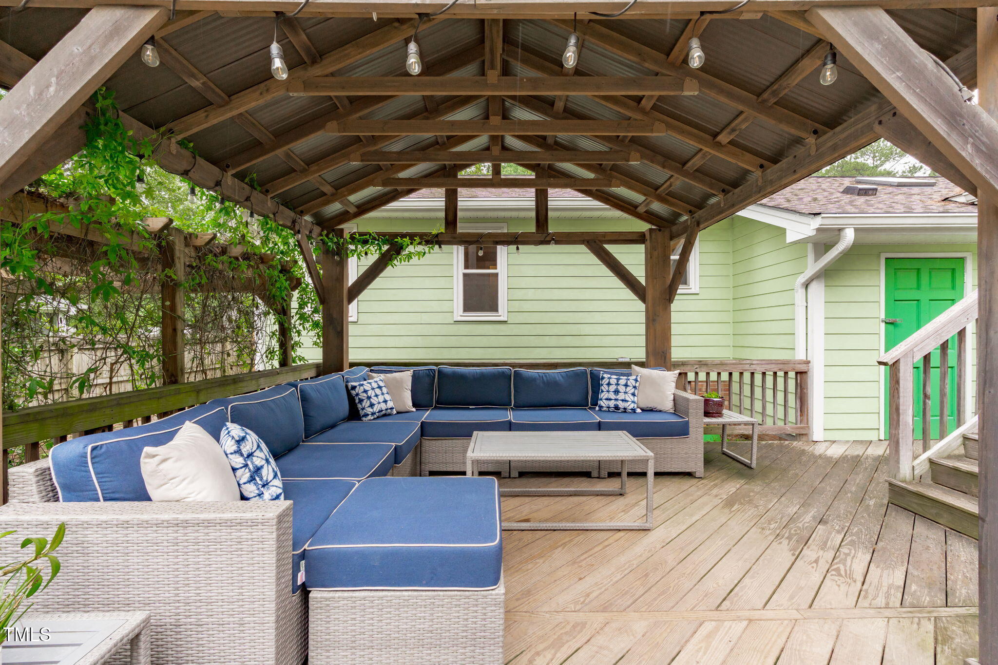 7304 St Ledger Drive Raleigh, NC 27613 - Photo 22 of 29 a outdoor living space with furniture and a black umbrella
