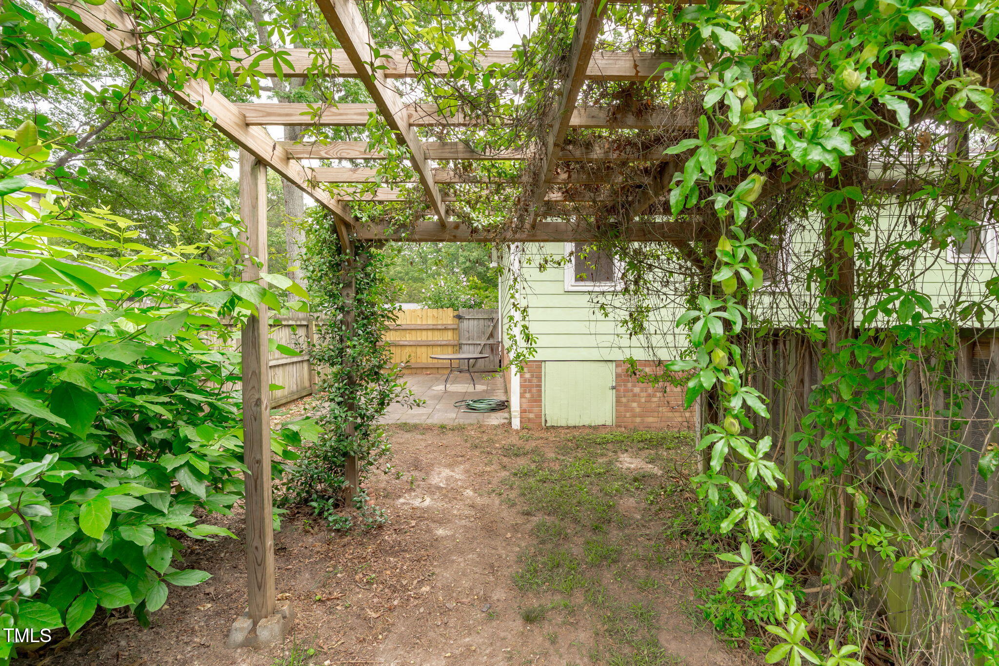 7304 St Ledger Drive Raleigh, NC 27613 - Photo 26 of 29 a view of a yard with plants and large trees