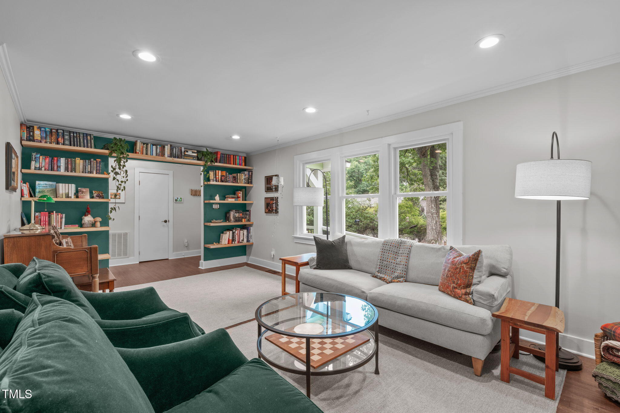 7304 St Ledger Drive Raleigh, NC 27613 - Photo 3 of 29 a living room with furniture and a book shelf