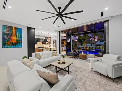 a kitchen with stainless steel appliances a stove and a flat screen tv