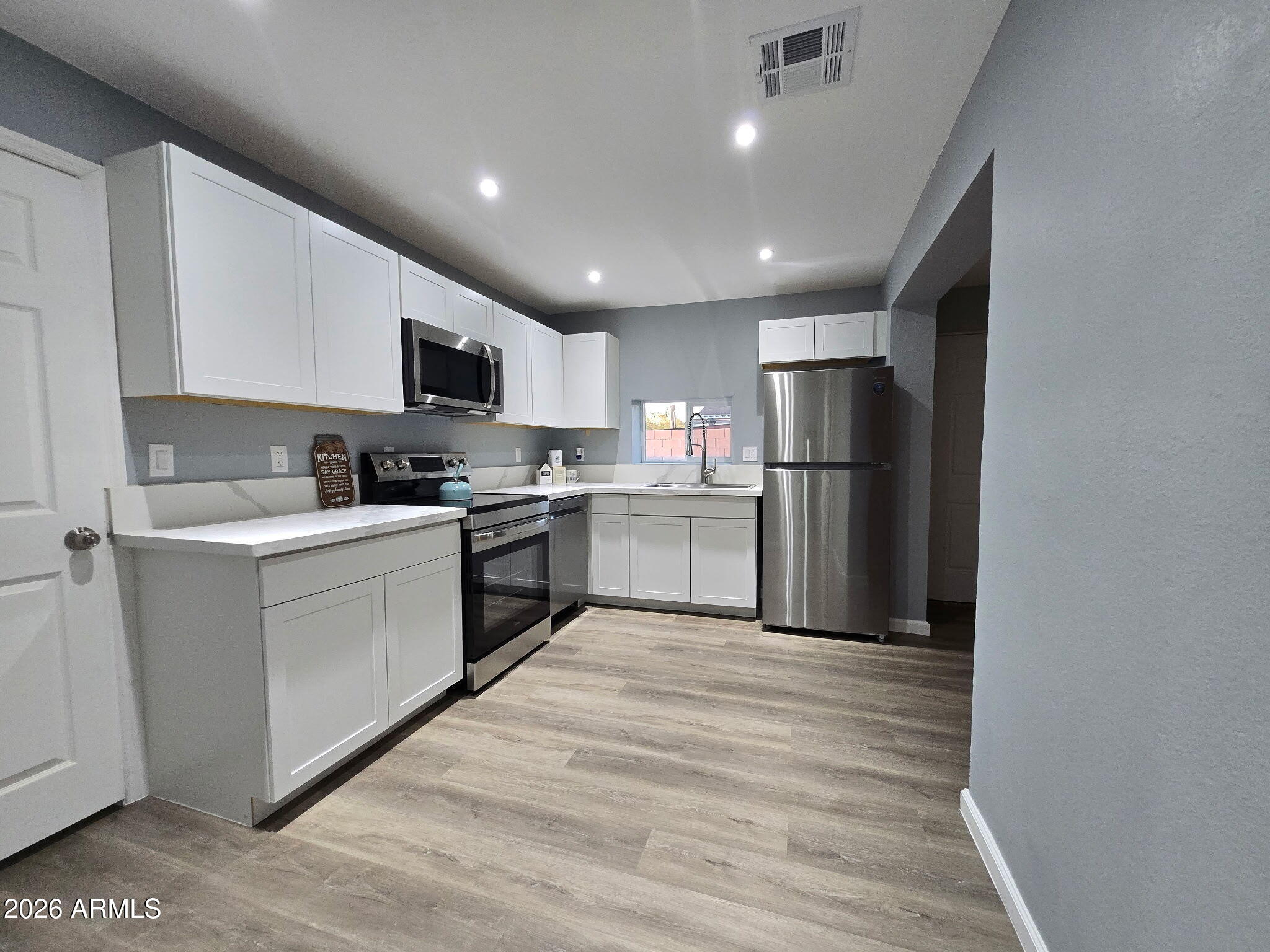 770 South Pinal Drive Apache Junction, AZ 85120 - Photo 22 of 51 a kitchen with a refrigerator a stove top oven a sink and dishwasher