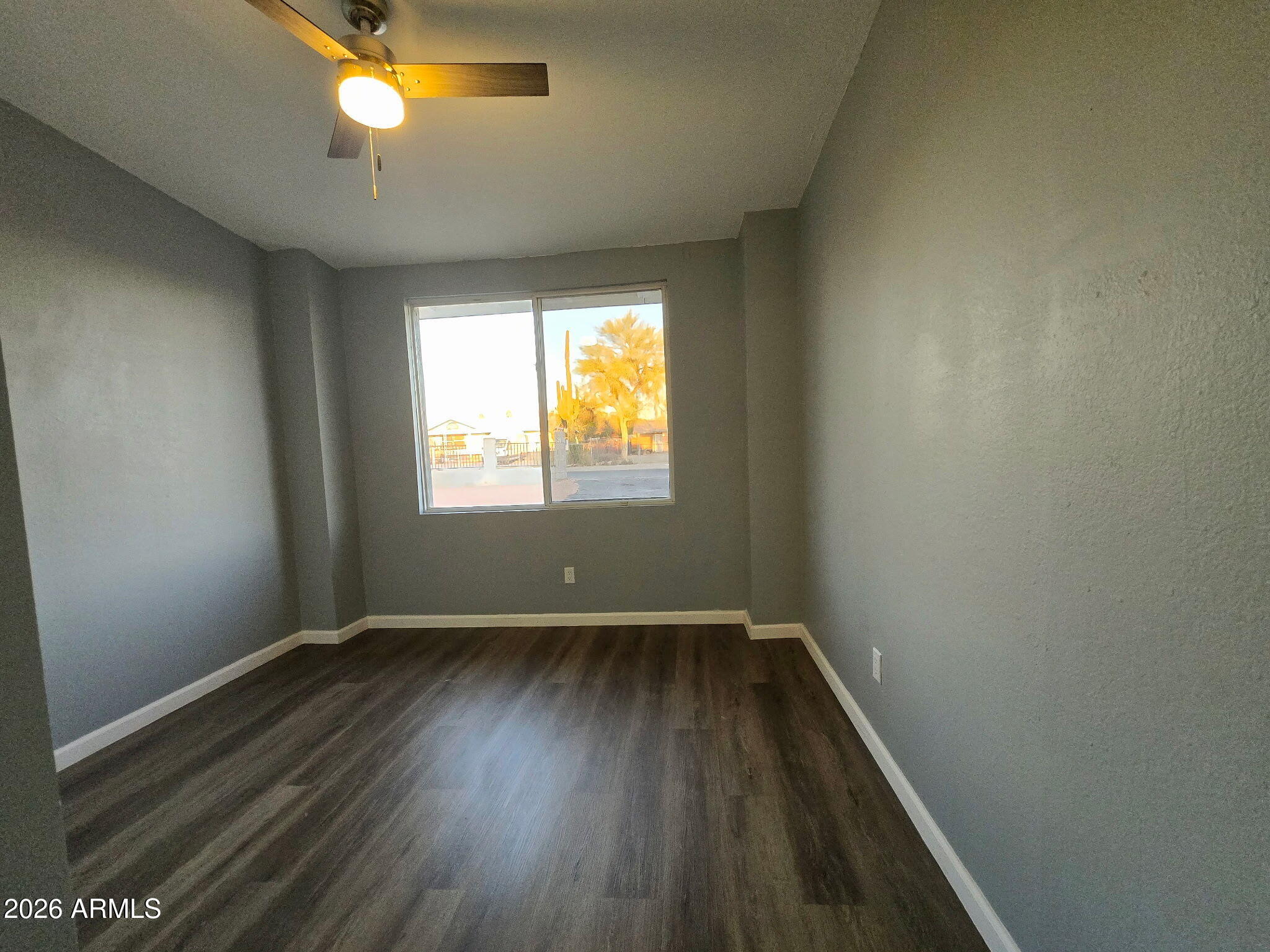 770 South Pinal Drive Apache Junction, AZ 85120 - Photo 25 of 51 an empty room with wooden floor and windows
