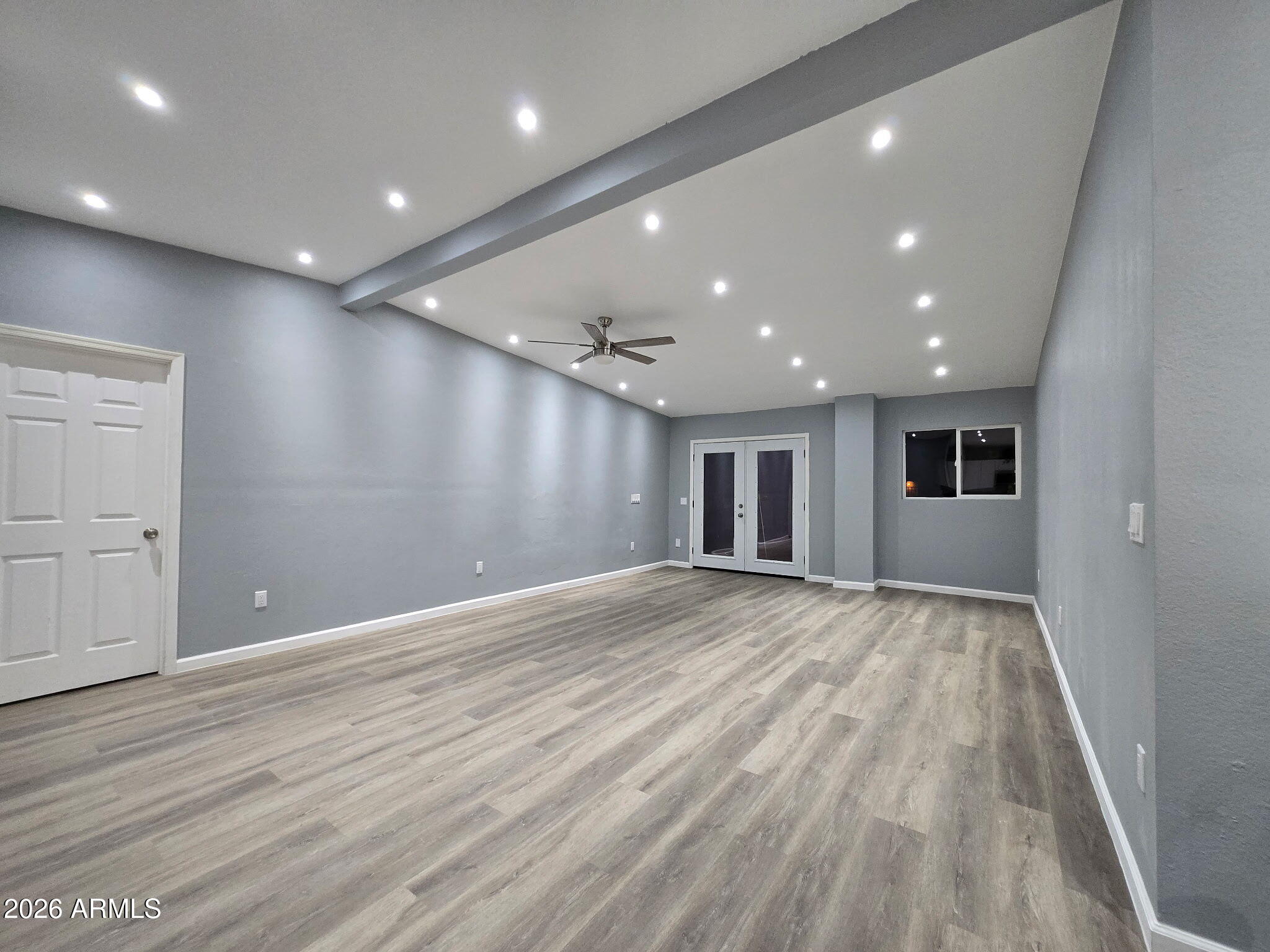 770 South Pinal Drive Apache Junction, AZ 85120 - Photo 33 of 51 a view of an empty room with wooden floor and kitchen