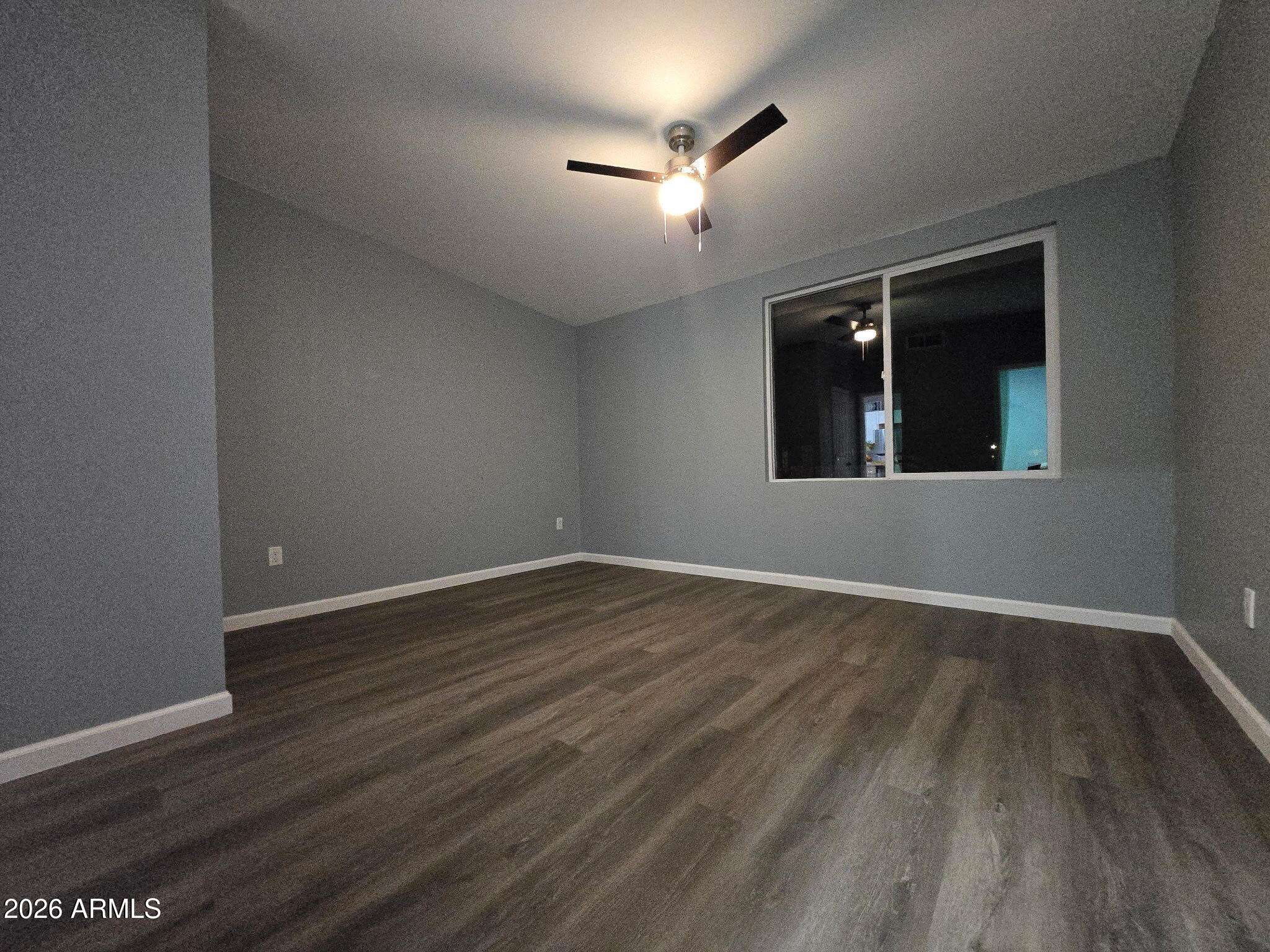 770 South Pinal Drive Apache Junction, AZ 85120 - Photo 34 of 51 a view of an empty room with wooden floor and a window