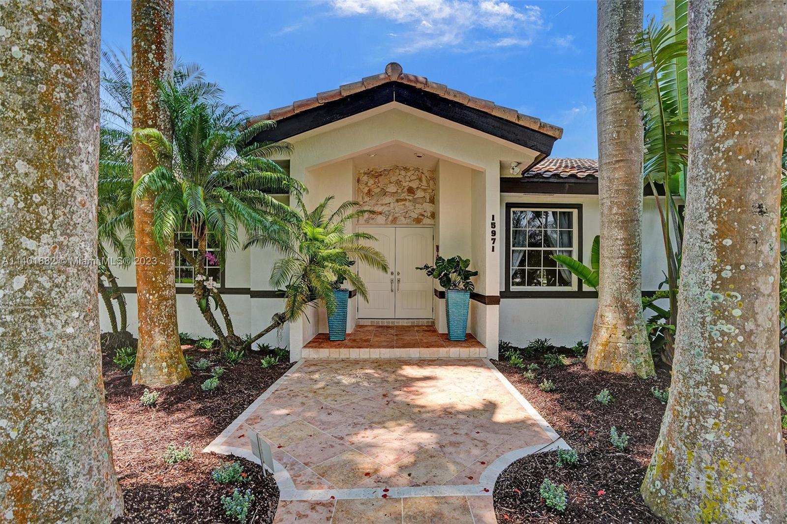 15971 Southwest 252nd Street Homestead, FL 33031 - Photo 1 of 92 a front view of a house with garden