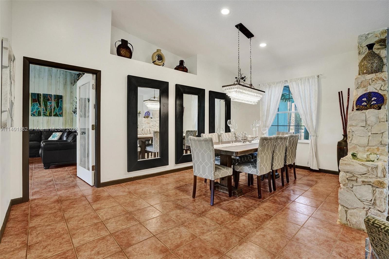 15971 Southwest 252nd Street Homestead, FL 33031 - Photo 18 of 92 a view of a dining room with furniture and chandelier