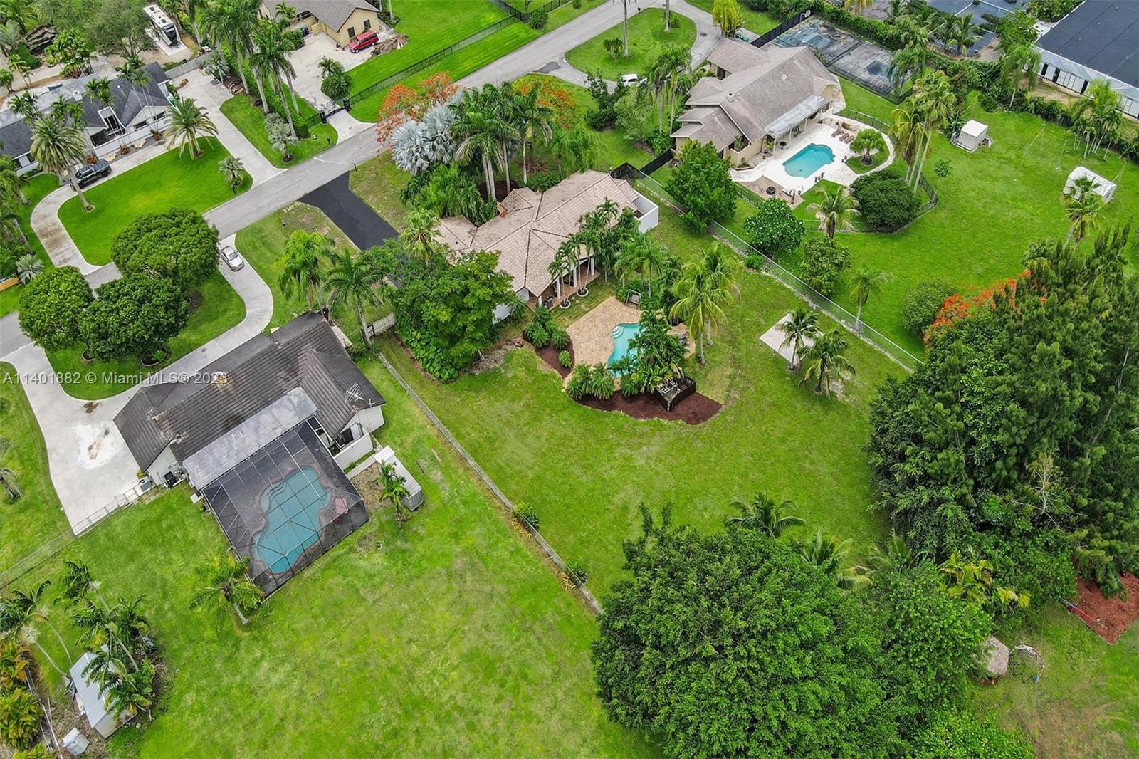 15971 Southwest 252nd Street Homestead, FL 33031 - Photo 2 of 92 an aerial view of residential house with outdoor space and trees all around