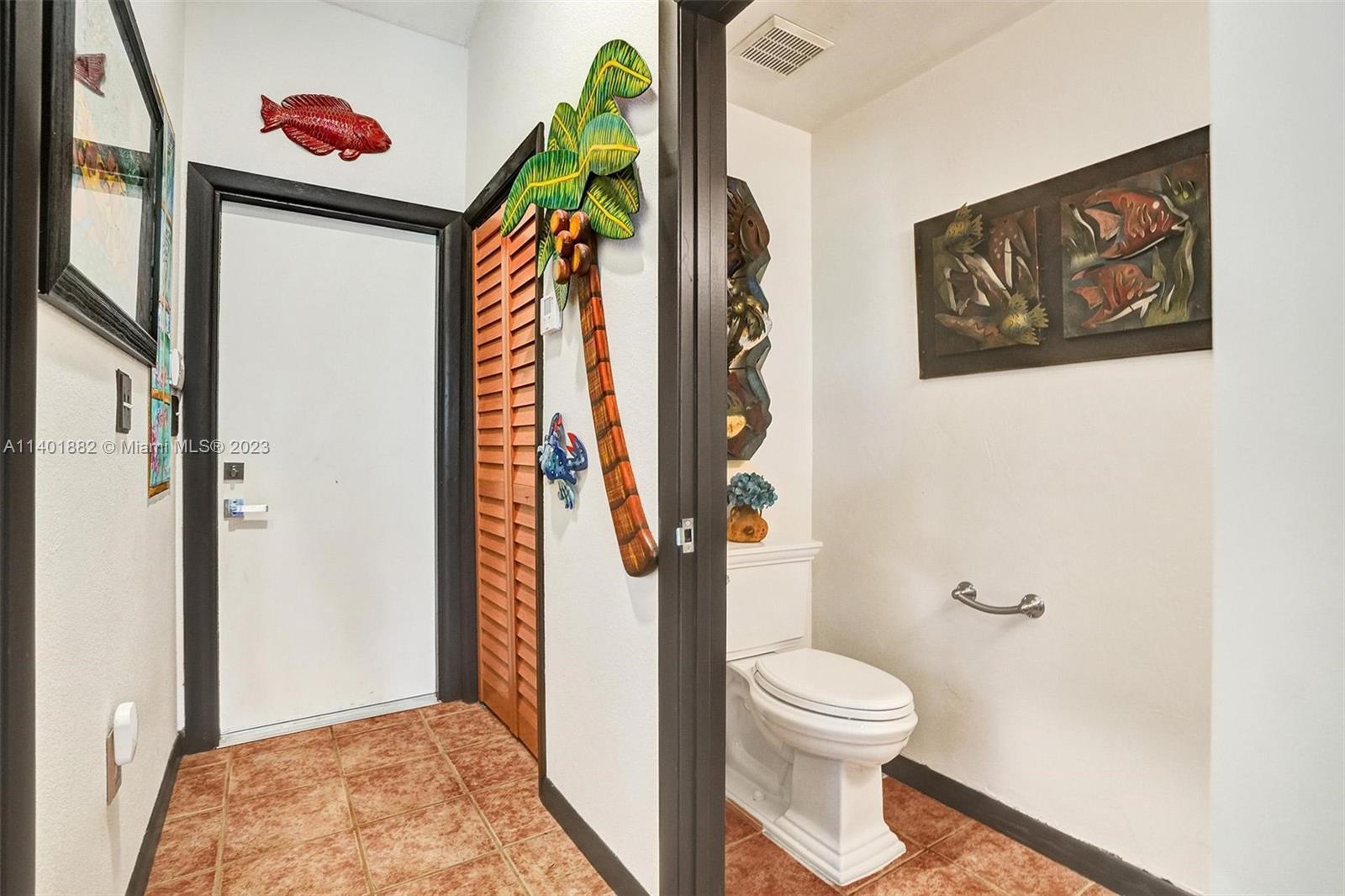 15971 Southwest 252nd Street Homestead, FL 33031 - Photo 27 of 92 a bathroom with a toilet and a shower curtain