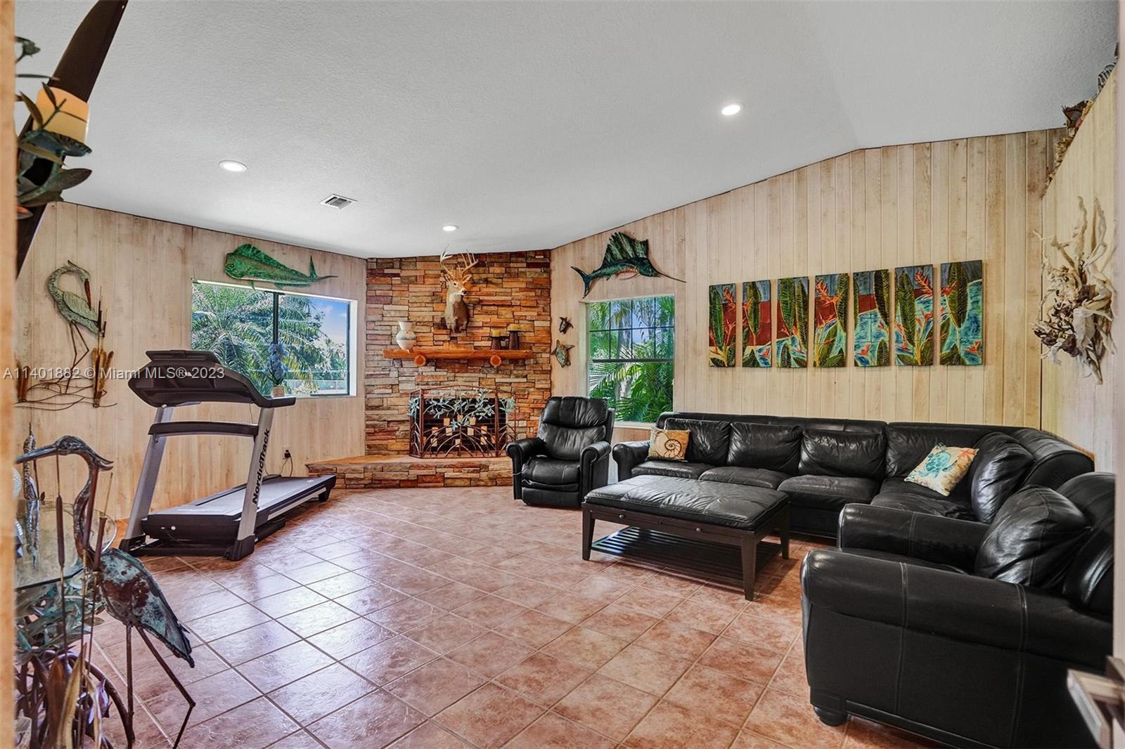 15971 Southwest 252nd Street Homestead, FL 33031 - Photo 28 of 92 a living room with furniture a window and a flat screen tv