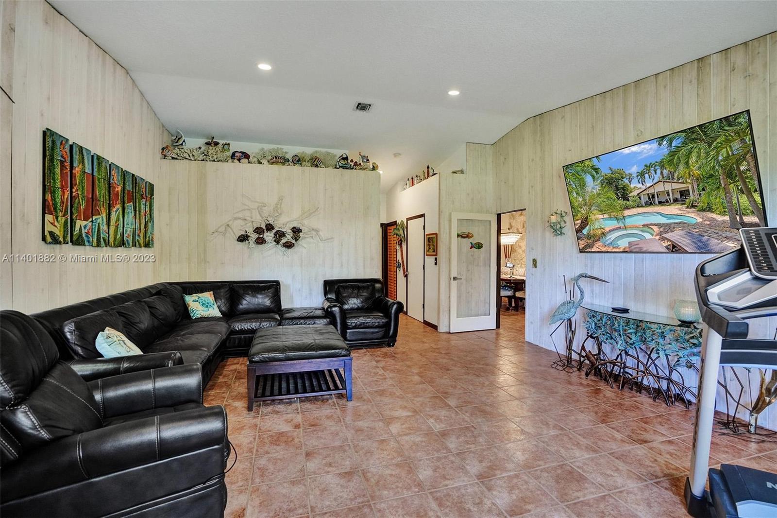 15971 Southwest 252nd Street Homestead, FL 33031 - Photo 32 of 92 a living room with furniture and a flat screen tv