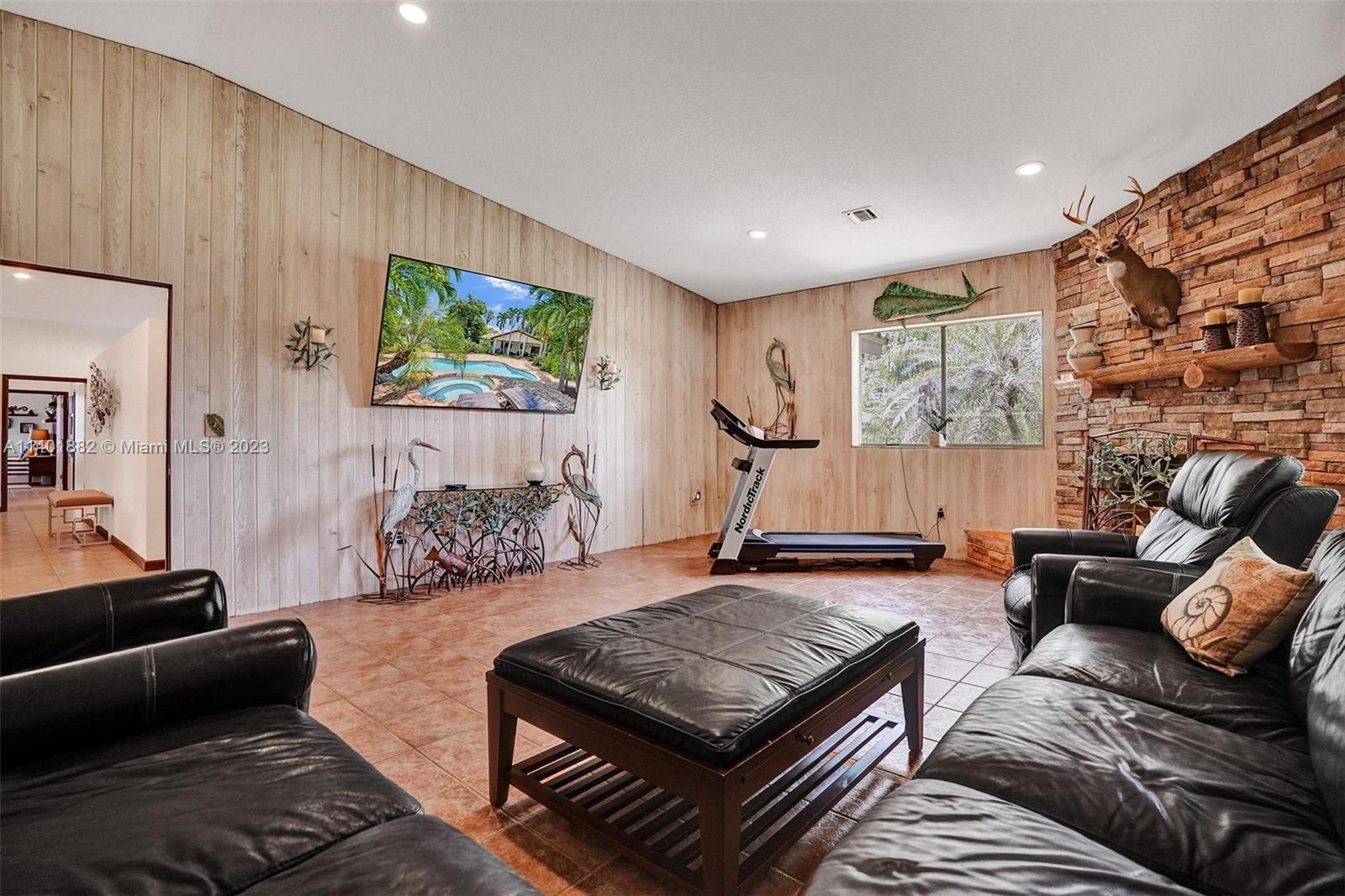 15971 Southwest 252nd Street Homestead, FL 33031 - Photo 33 of 92 a living room with furniture and a flat screen tv