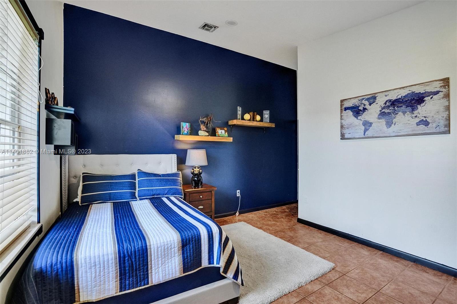 15971 Southwest 252nd Street Homestead, FL 33031 - Photo 36 of 92 a bedroom with a bed and wooden floor