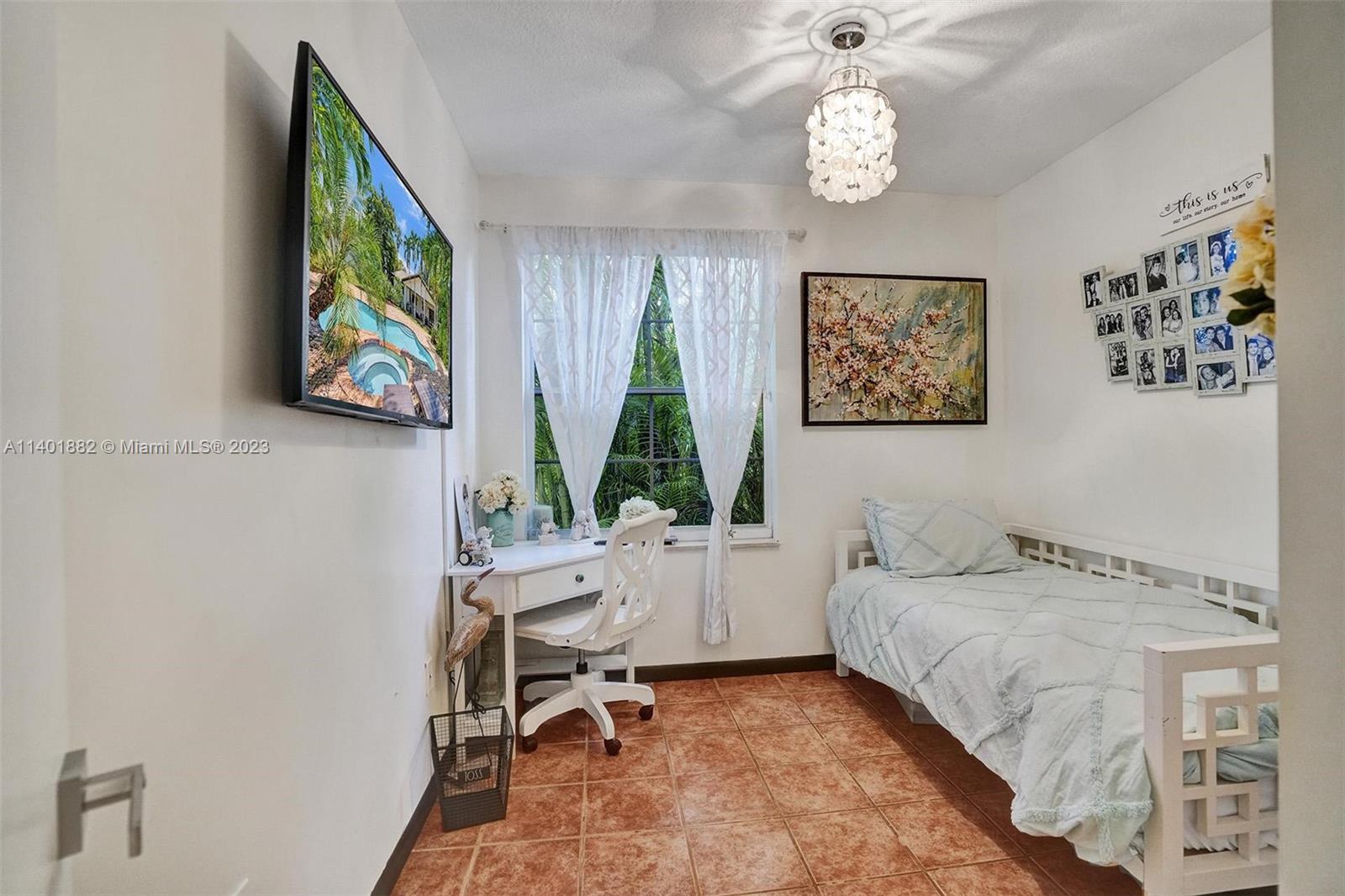 15971 Southwest 252nd Street Homestead, FL 33031 - Photo 38 of 92 a bedroom with a bed and a table