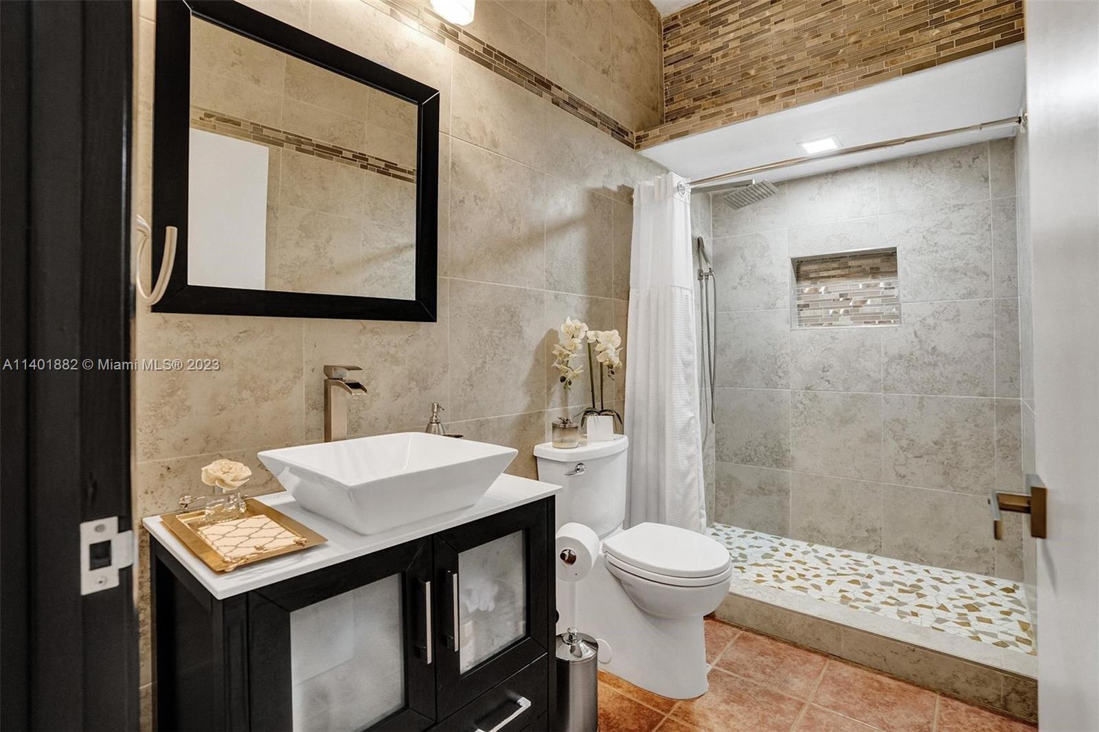 15971 Southwest 252nd Street Homestead, FL 33031 - Photo 42 of 92 a bathroom with a sink a toilet and shower