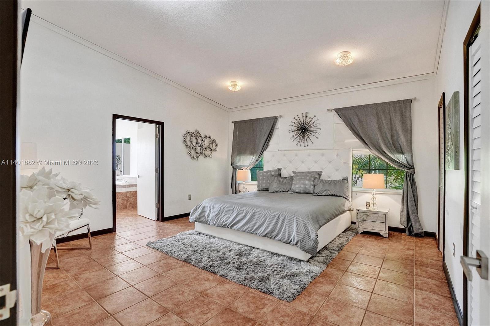 15971 Southwest 252nd Street Homestead, FL 33031 - Photo 44 of 92 a bedroom with a large bed and a window