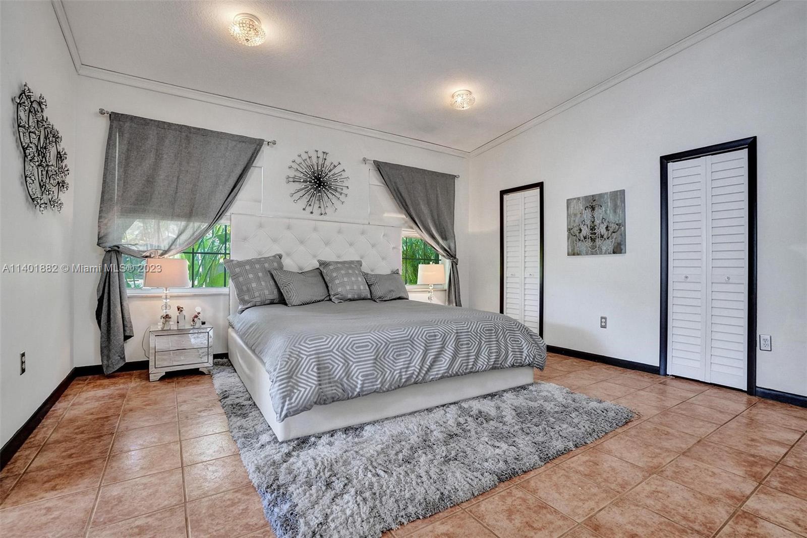 15971 Southwest 252nd Street Homestead, FL 33031 - Photo 45 of 92 a bedroom with a large bed and a window