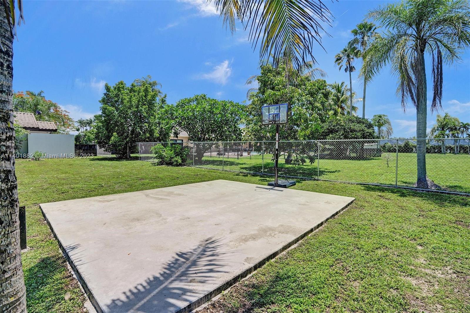 15971 Southwest 252nd Street Homestead, FL 33031 - Photo 64 of 92 a view of a backyard with palm trees