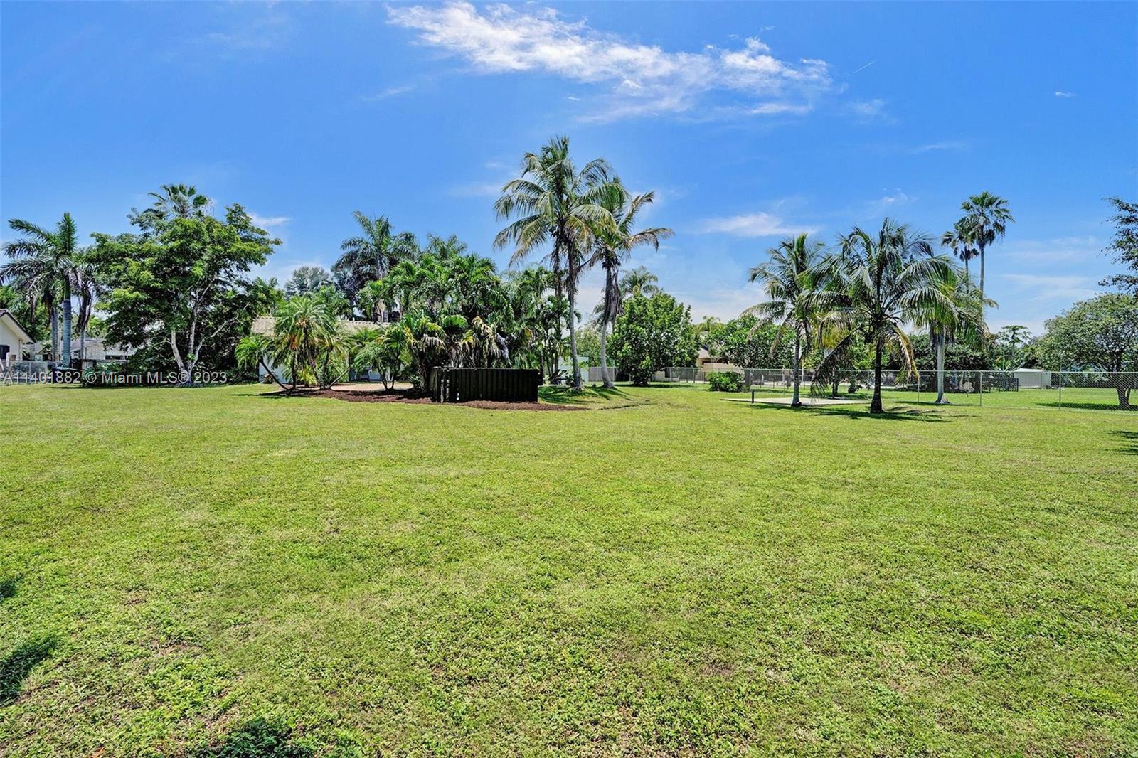 15971 Southwest 252nd Street Homestead, FL 33031 - Photo 67 of 92 a view of a garden with a building in the background