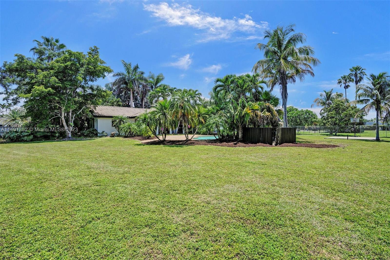 15971 Southwest 252nd Street Homestead, FL 33031 - Photo 69 of 92 a view of house with garden space and trees