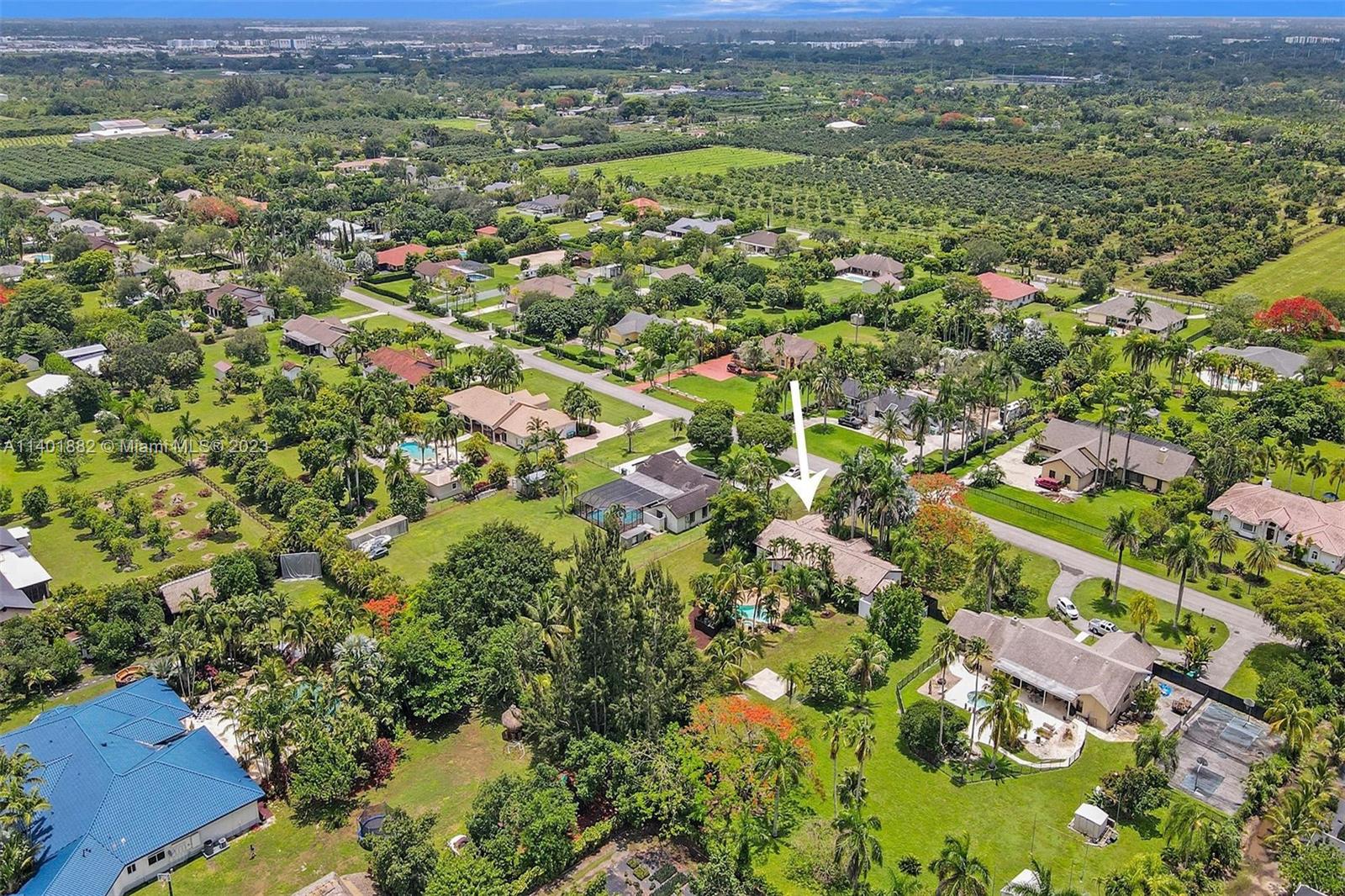 15971 Southwest 252nd Street Homestead, FL 33031 - Photo 86 of 92 an aerial view of residential houses with outdoor space and trees