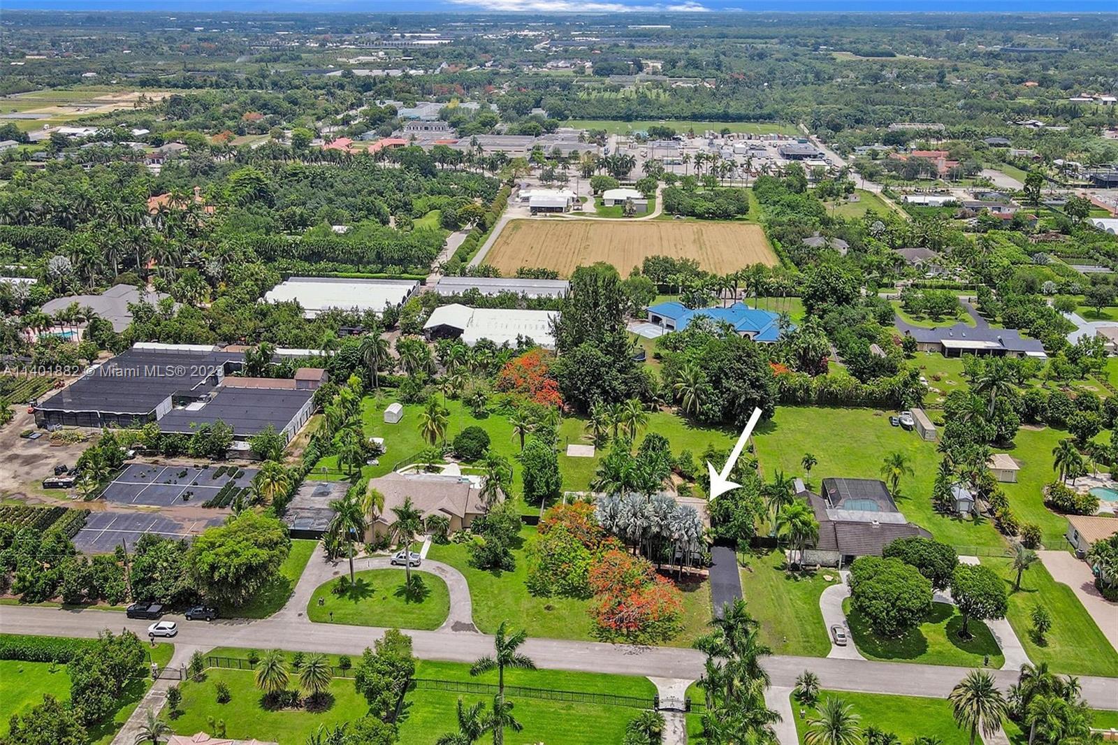 15971 Southwest 252nd Street Homestead, FL 33031 - Photo 89 of 92 an aerial view of residential houses with outdoor space and parking