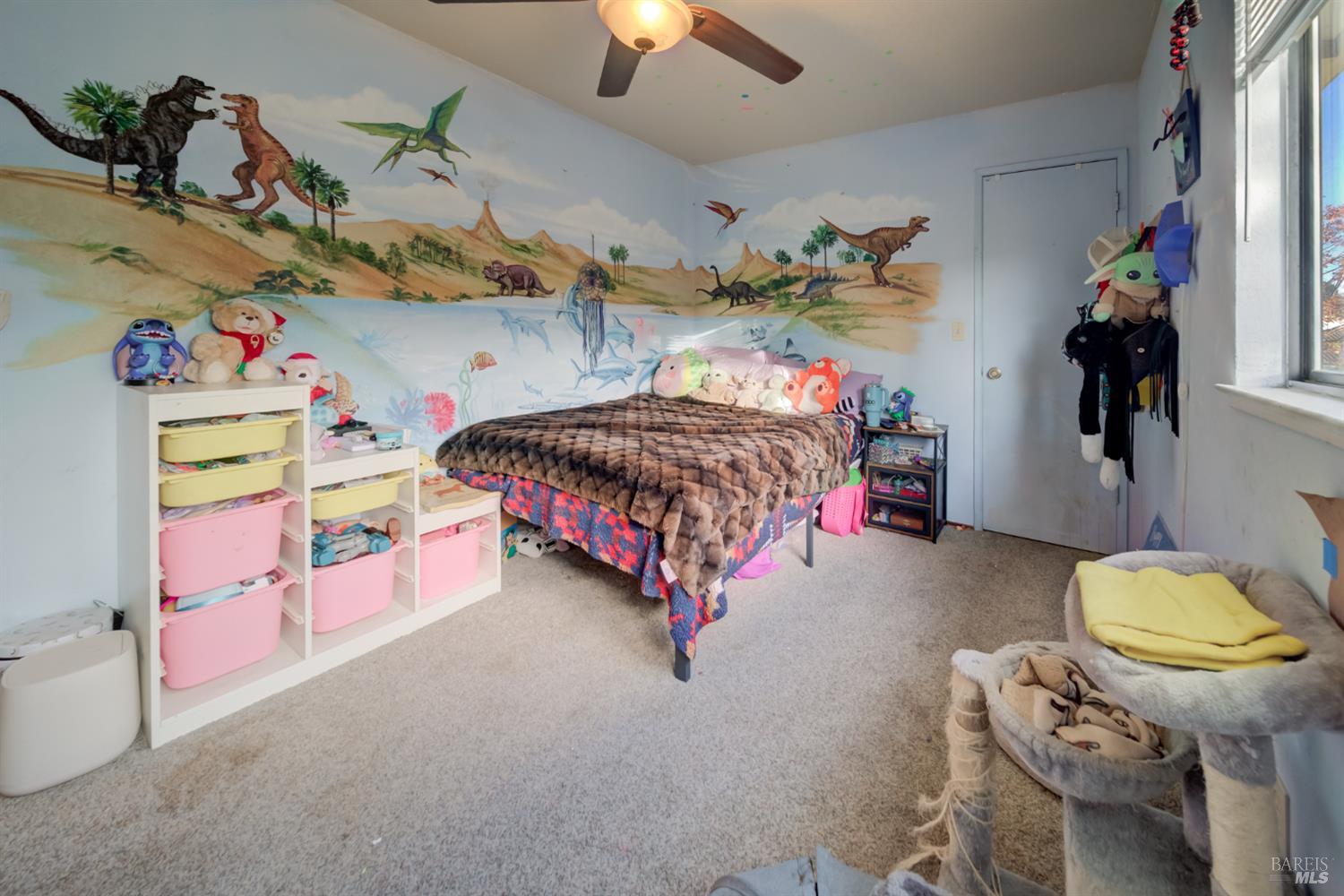 989 Suffolk Way Fairfield, CA 94533 - Photo 19 of 30 a bedroom with a bed and a chandelier