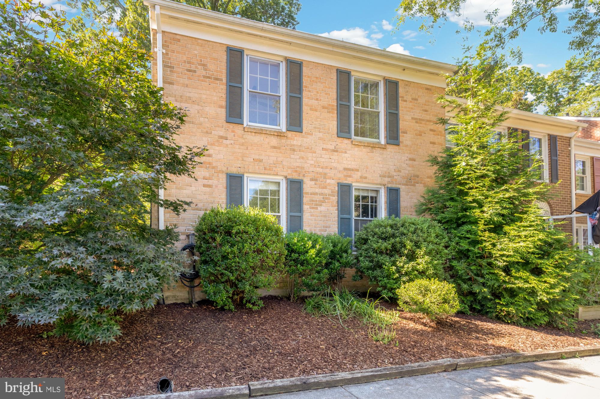 2429 Alsop Court Reston, VA 20191 - Photo 43 of 44 a front view of a house with lots of plants and trees