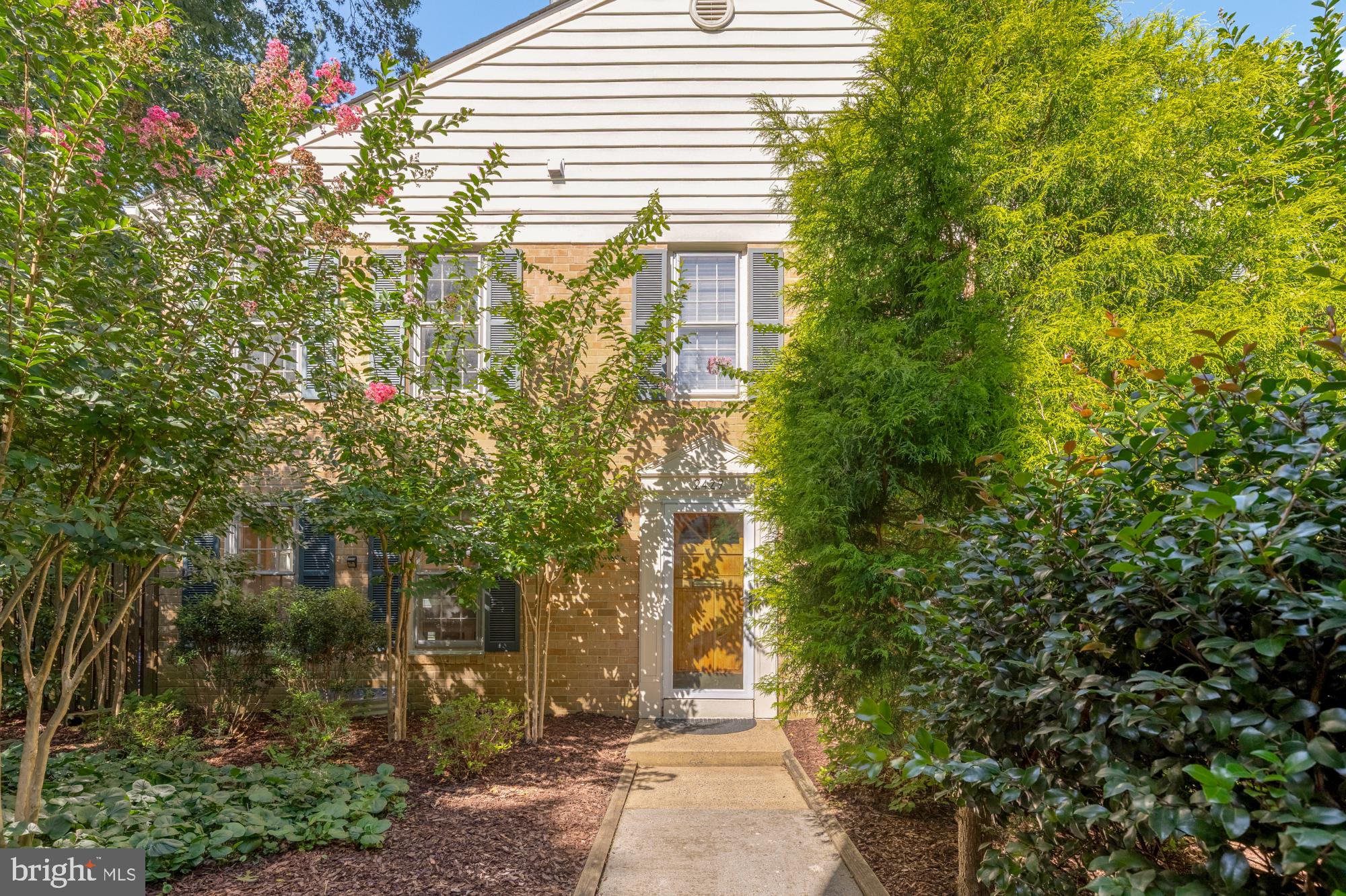 2429 Alsop Court Reston, VA 20191 - Photo 5 of 44 a yellow house with trees in front of it