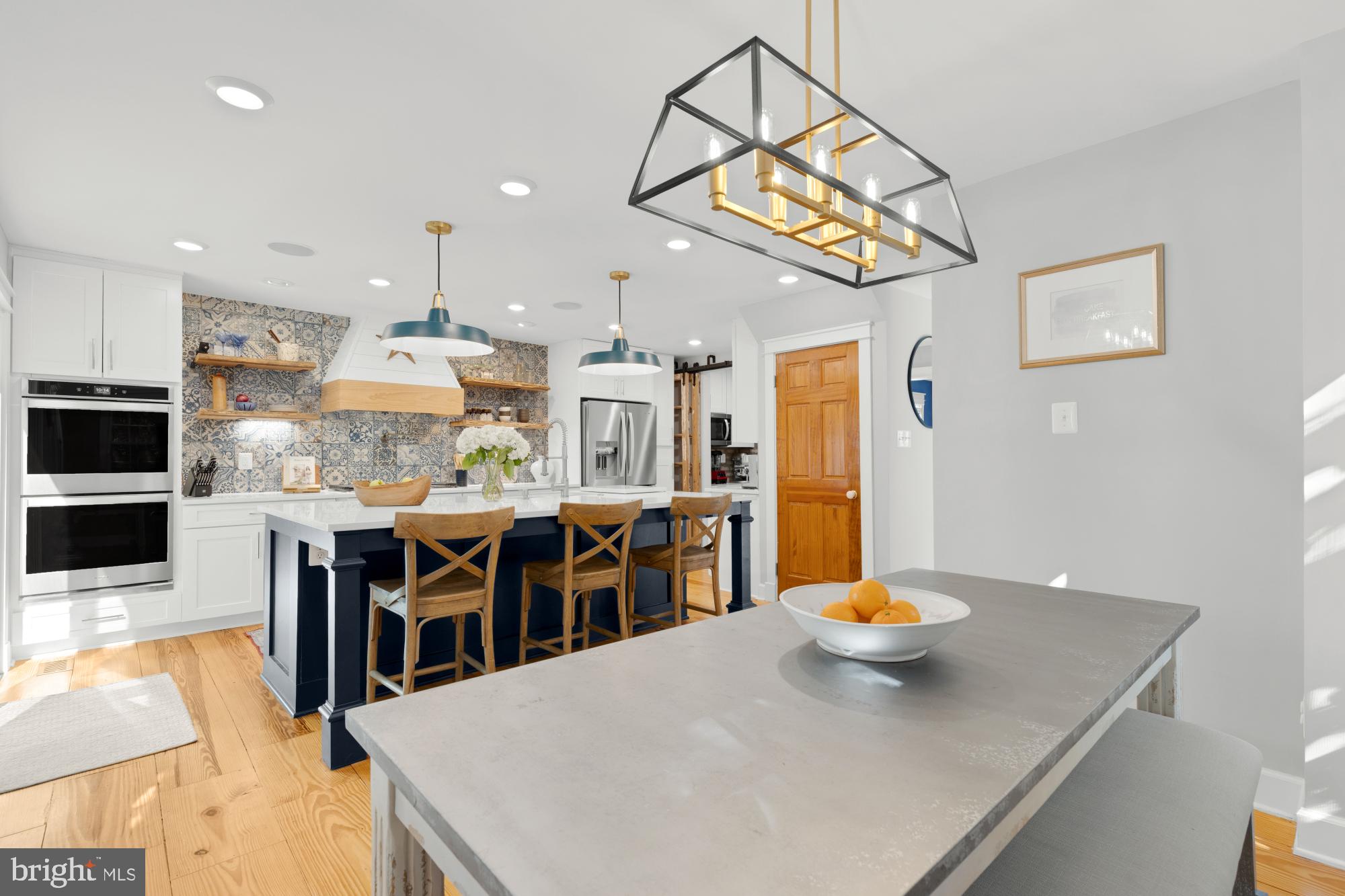 2429 Alsop Court Reston, VA 20191 - Photo 9 of 44 a kitchen with stainless steel appliances kitchen island granite countertop a table chairs and a sink